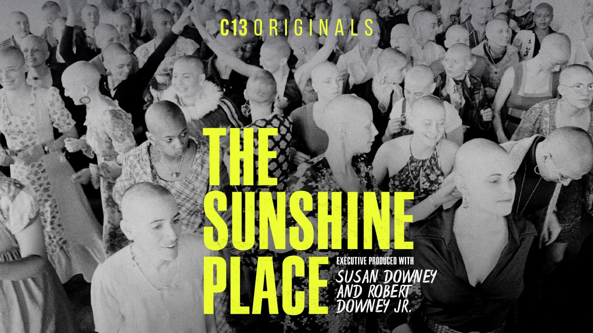 Crowd of Bald Women at an event, with yellow text overlay that reads 'C13 Originals: The Sunshine Place,' and smaller text indicating production credits to Susan Downey and Robert Downey Jr.