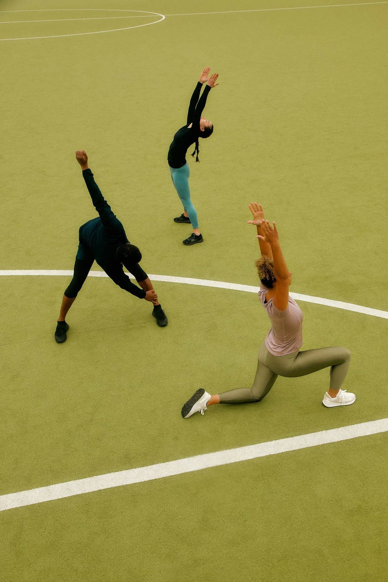 Athletes stretching on track and soccer field