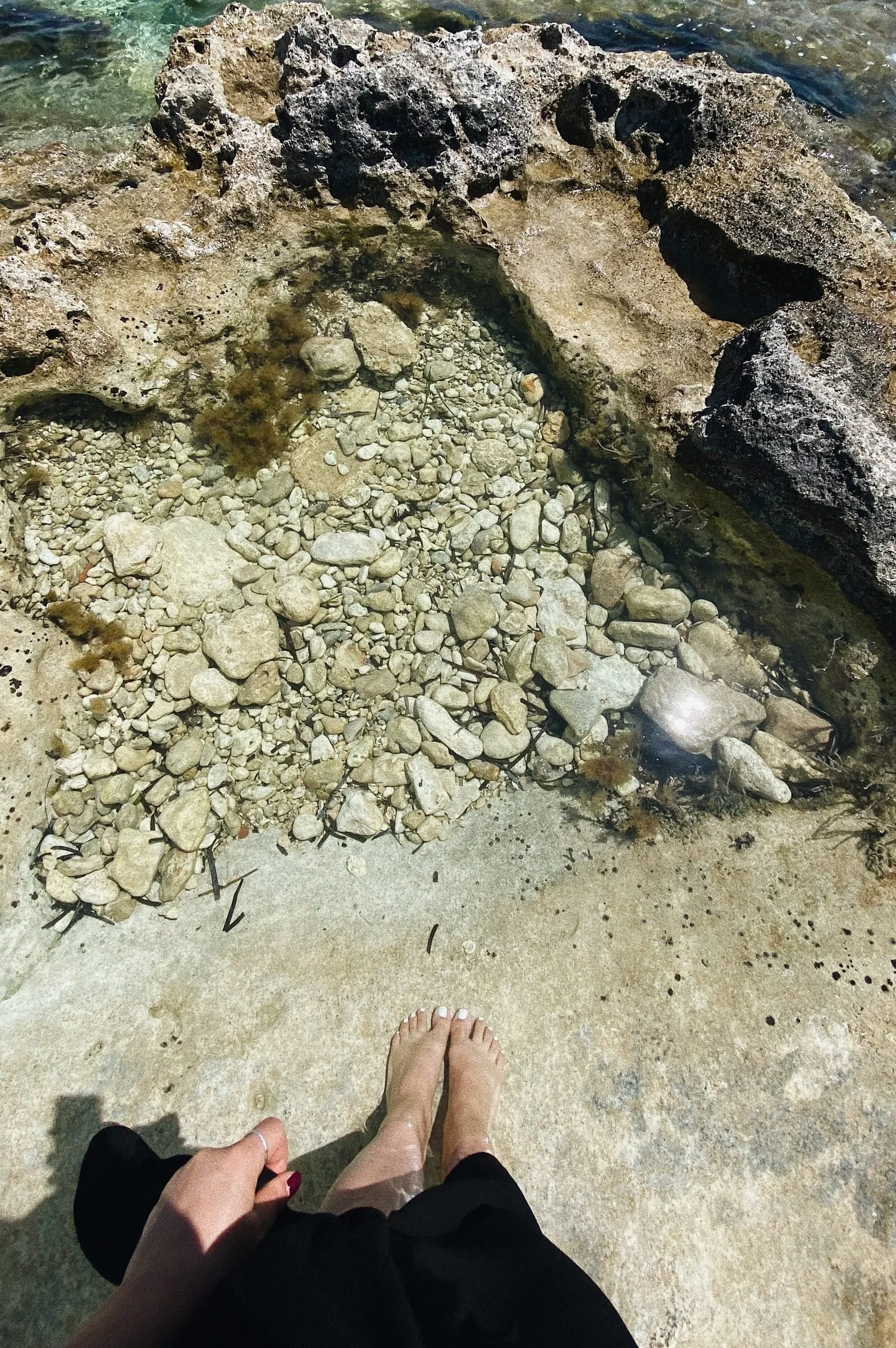 Feet on rocky coastline