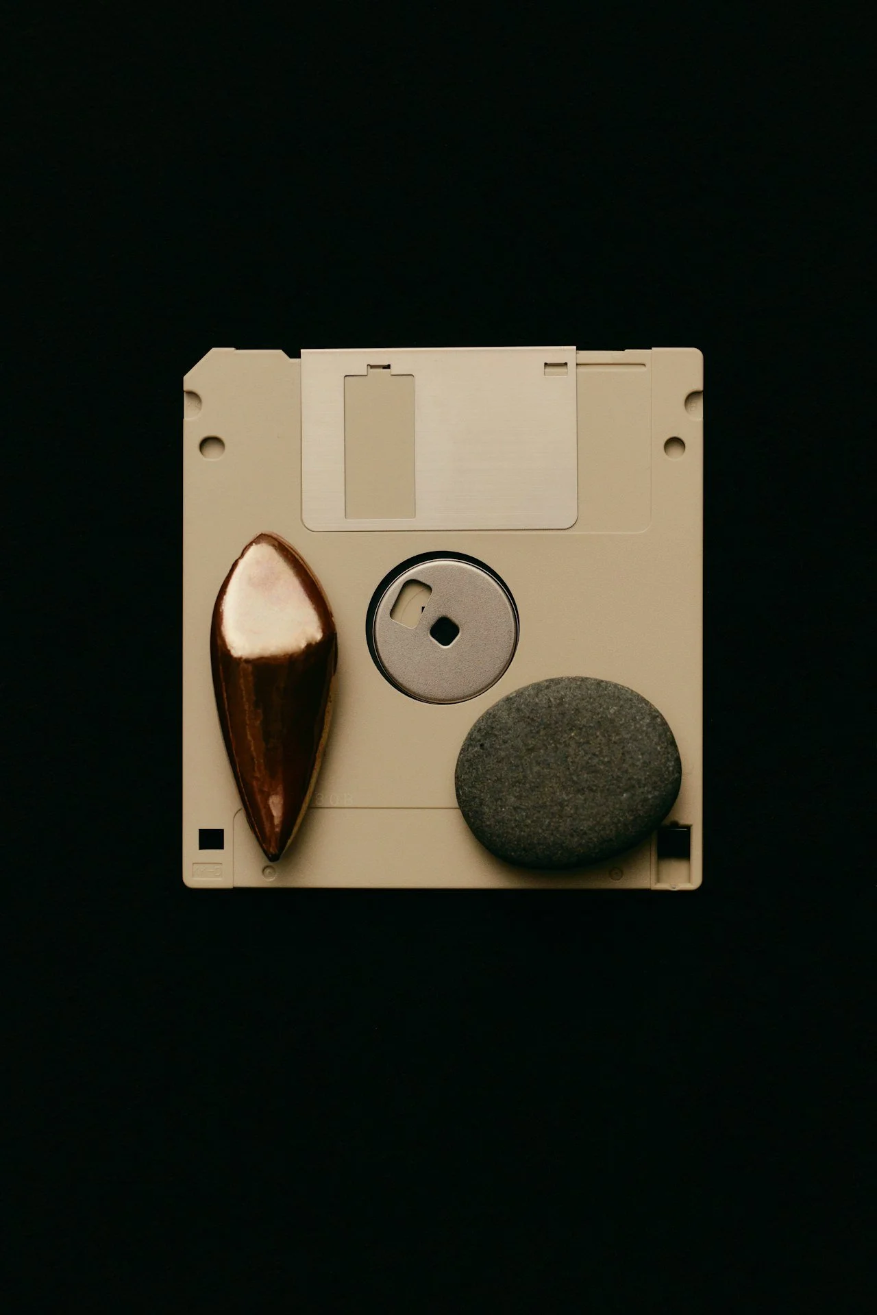 Floppy disk with stones and metal