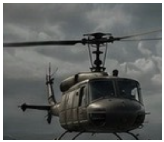 A helicopter flying in an overcast sky.
