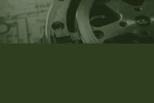 Close-up of a mechanical part or machine component, partially visible with metallic surfaces and bolts.