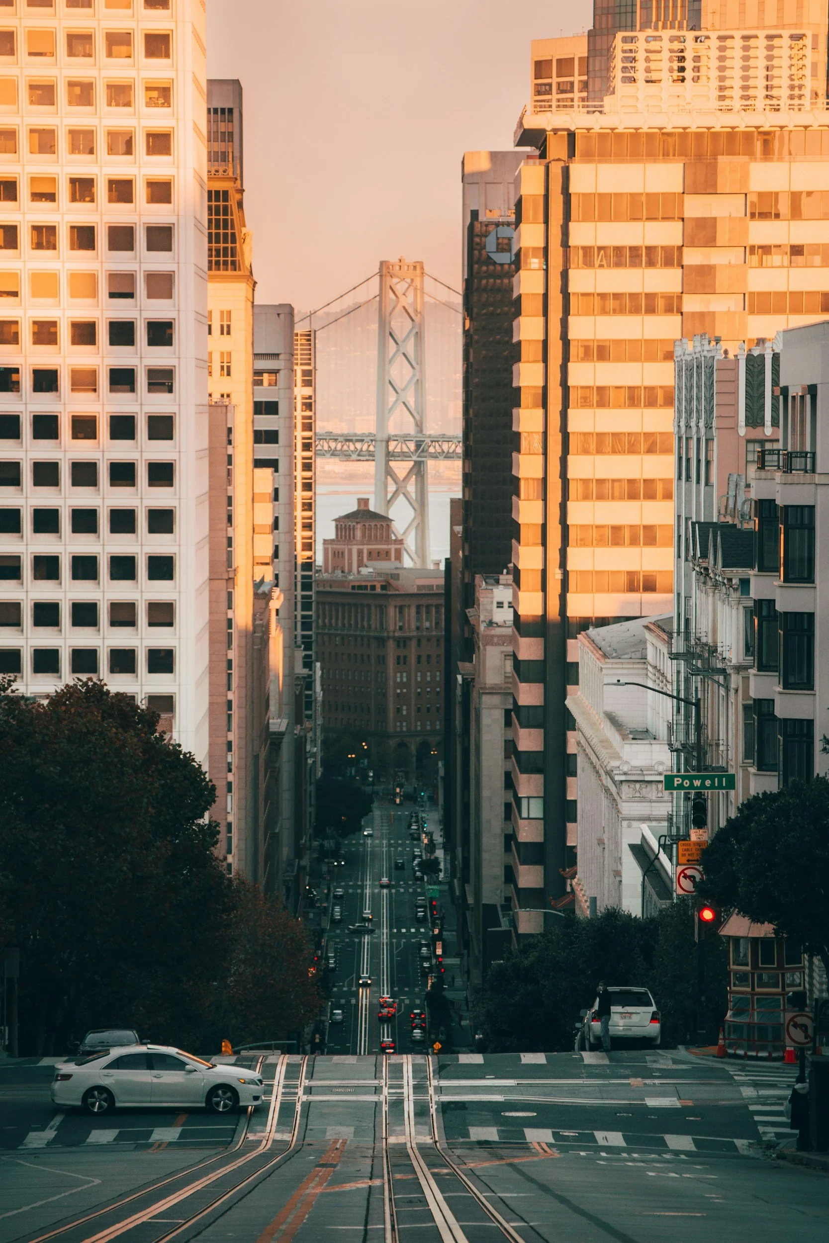 City skyline at sunset with tall buildings and a clear sky.