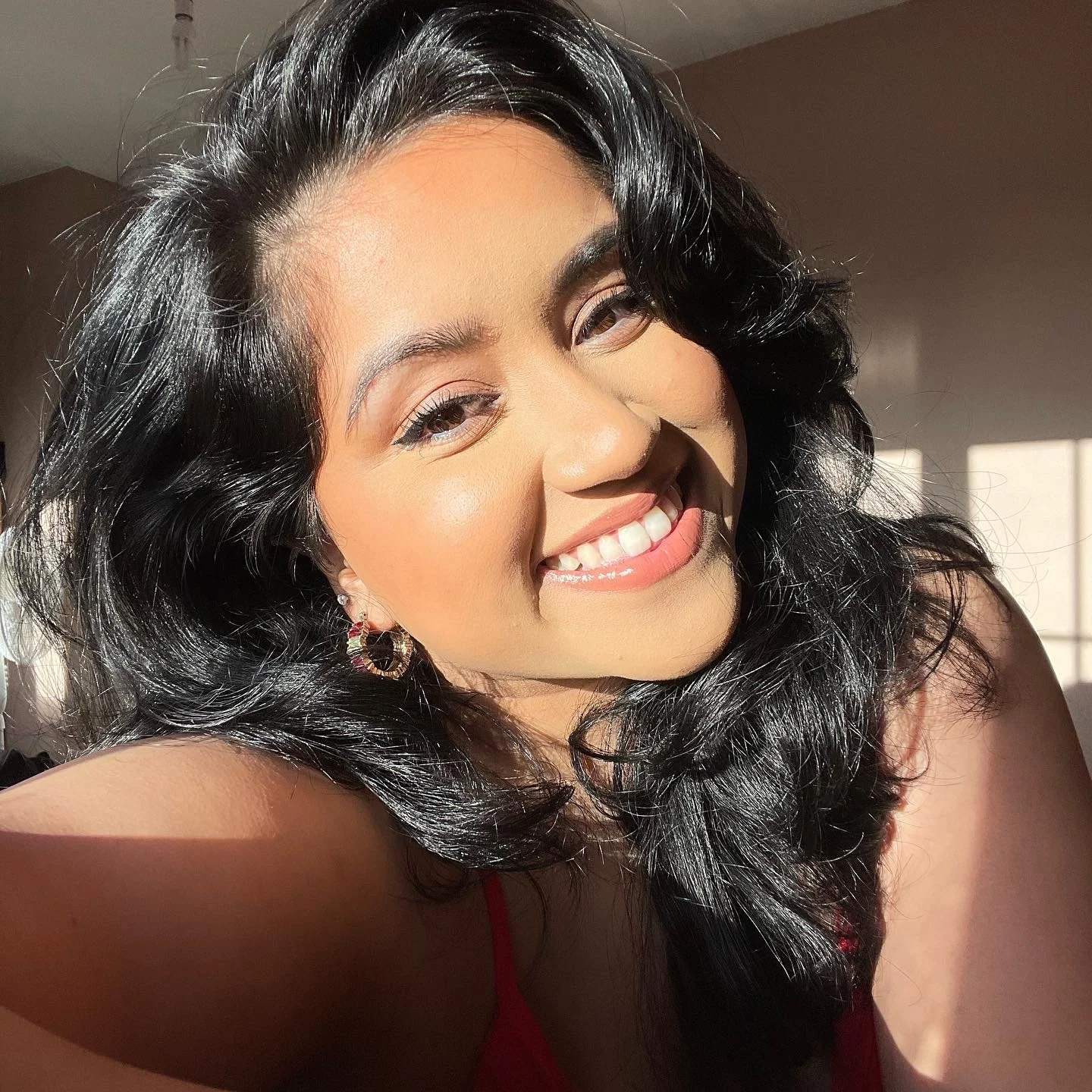 Smiling portrait of Priya Madden, founder of PMDN Creative.