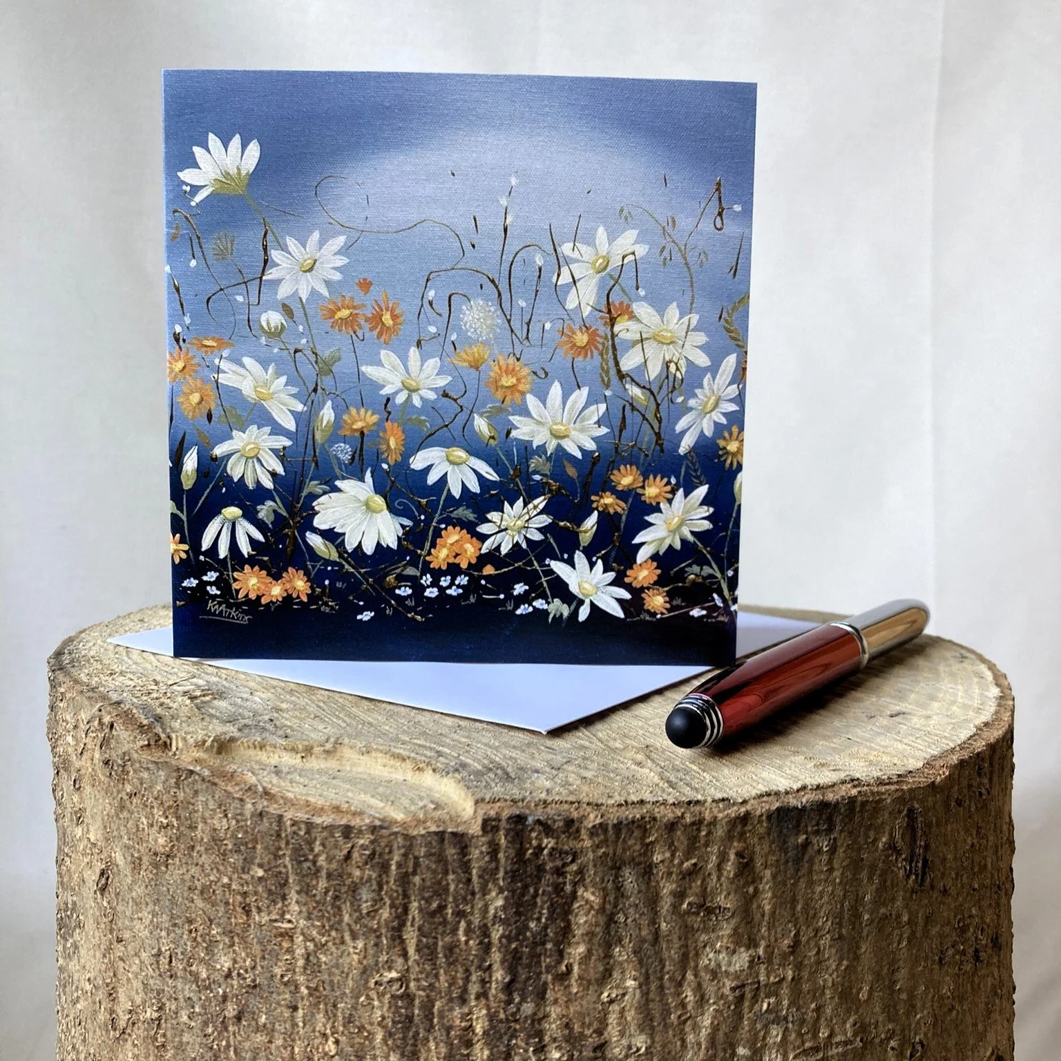 greetings card with a floral meadow scene featuring hawkweed and daisies