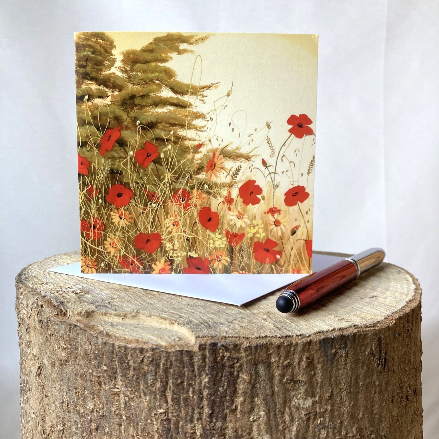 greetings card showing floral meadow with poppies and grasses and tree in the background