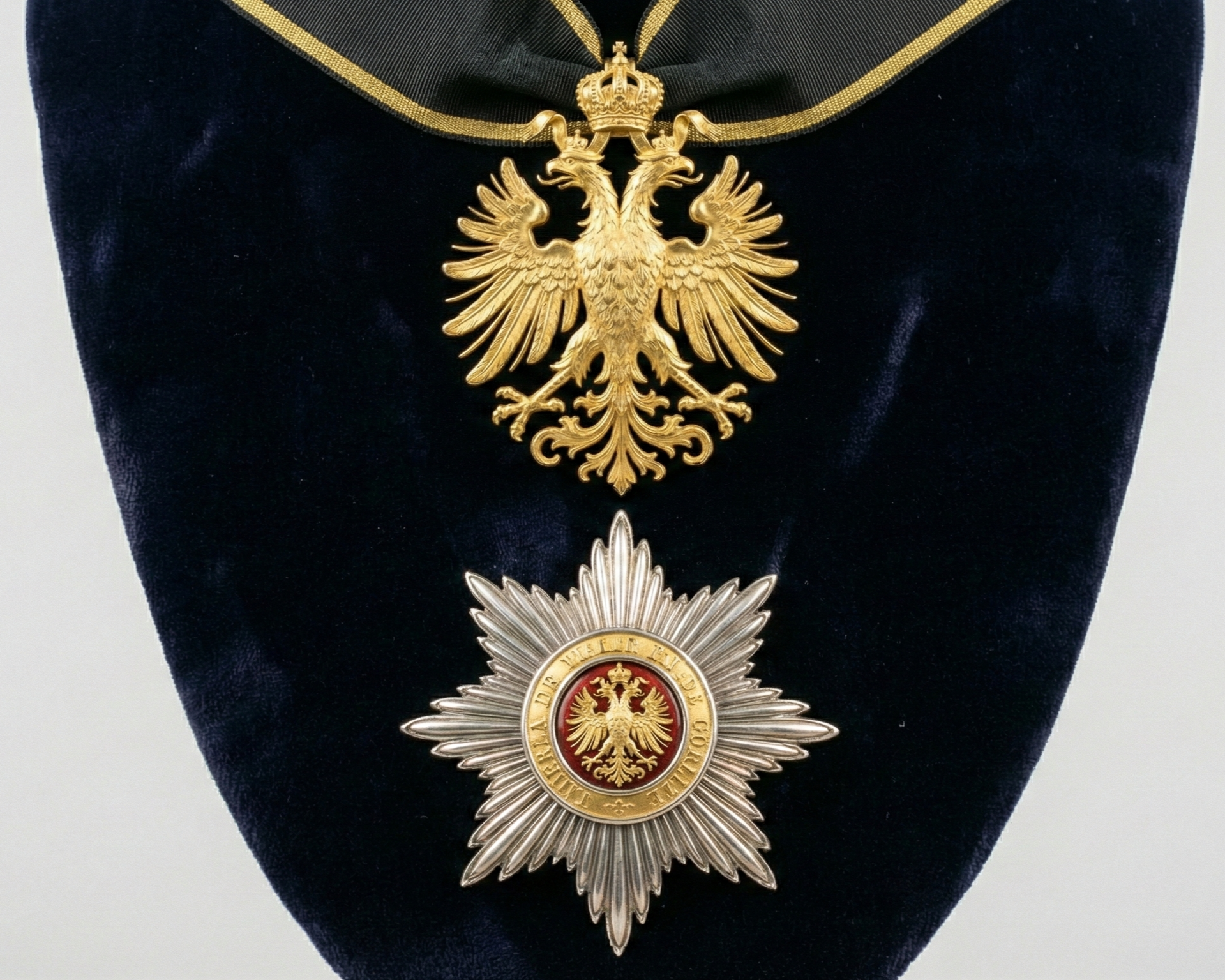 Gold and silver military or police medals on a dark blue fabric background.