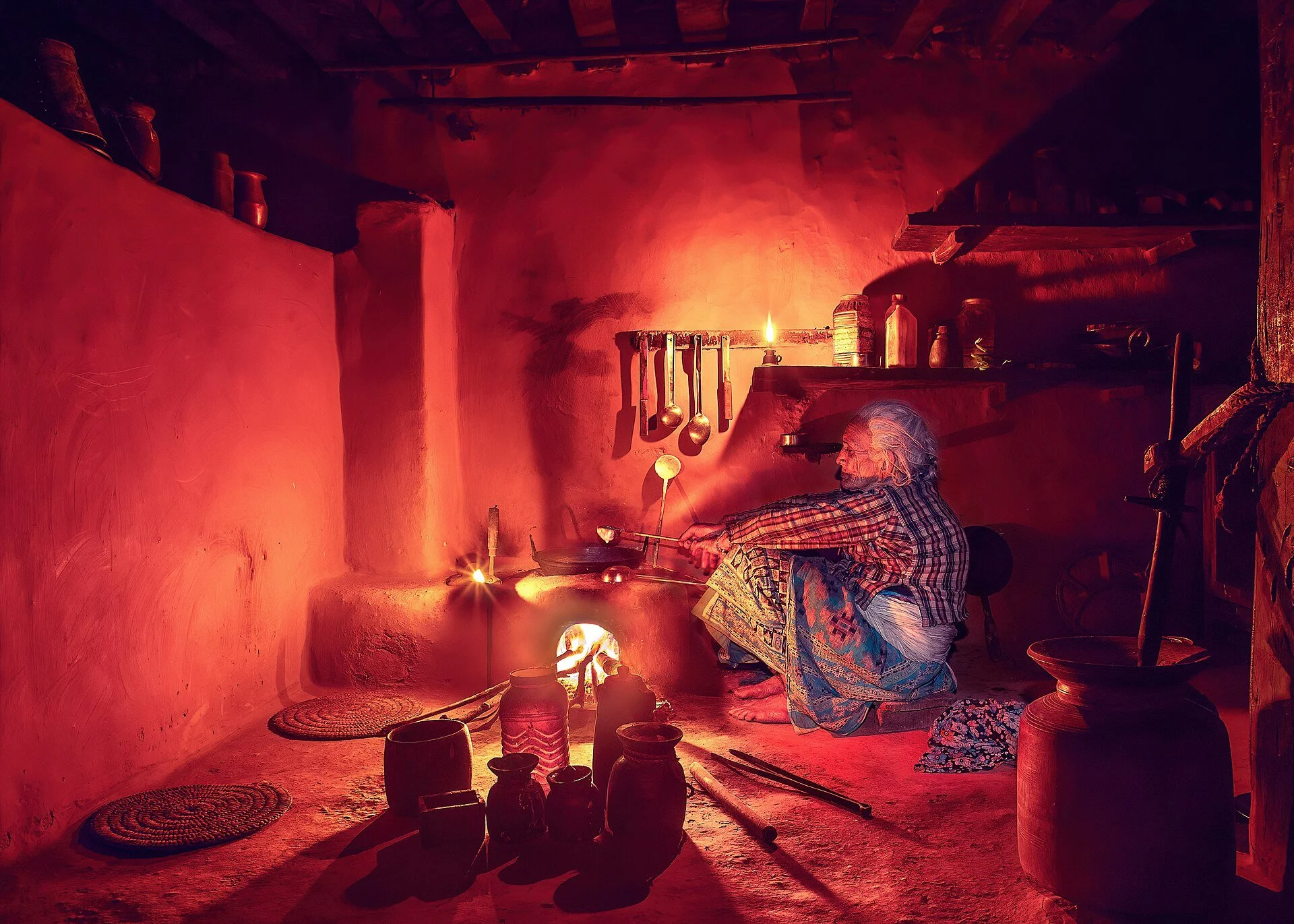 Traditional grandmother cooking a homemade meal using old-fashioned methods
