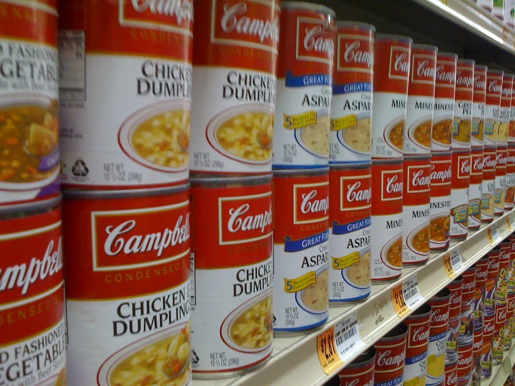 Assorted foods stored in labeled containers and jars for long-term preservation.