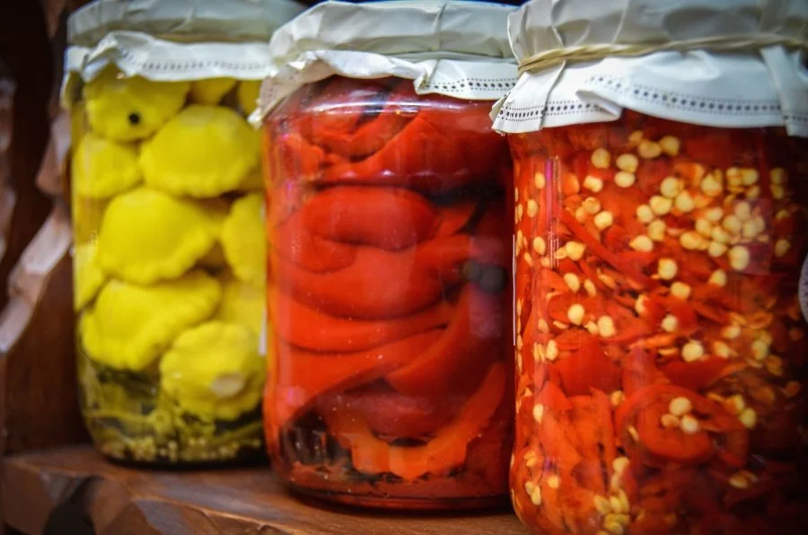 Jars and containers filled with preserved foods, showcasing traditional food preservation methods.