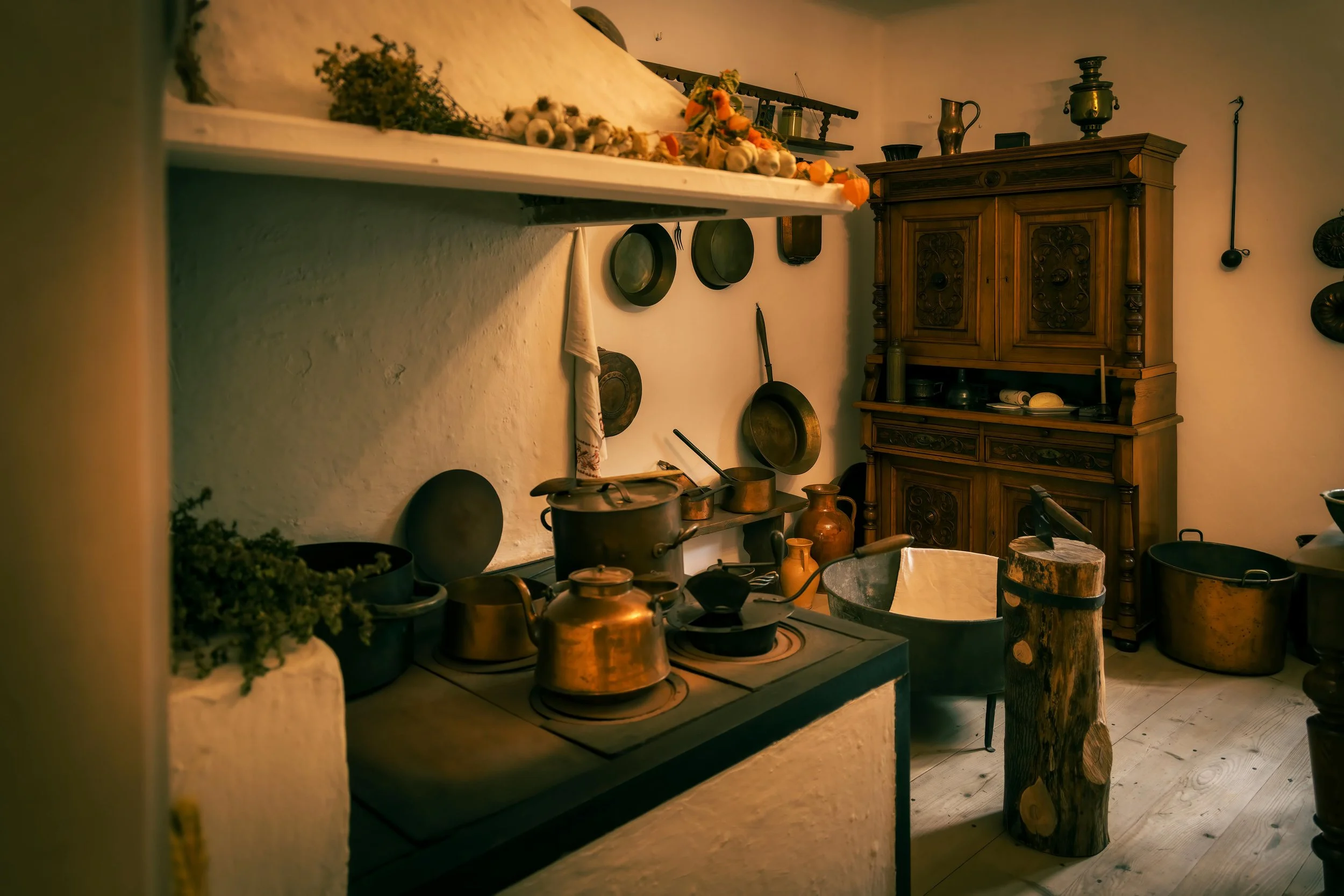 Vintage-style kitchen featuring traditional cooking utensils and classic home cookware