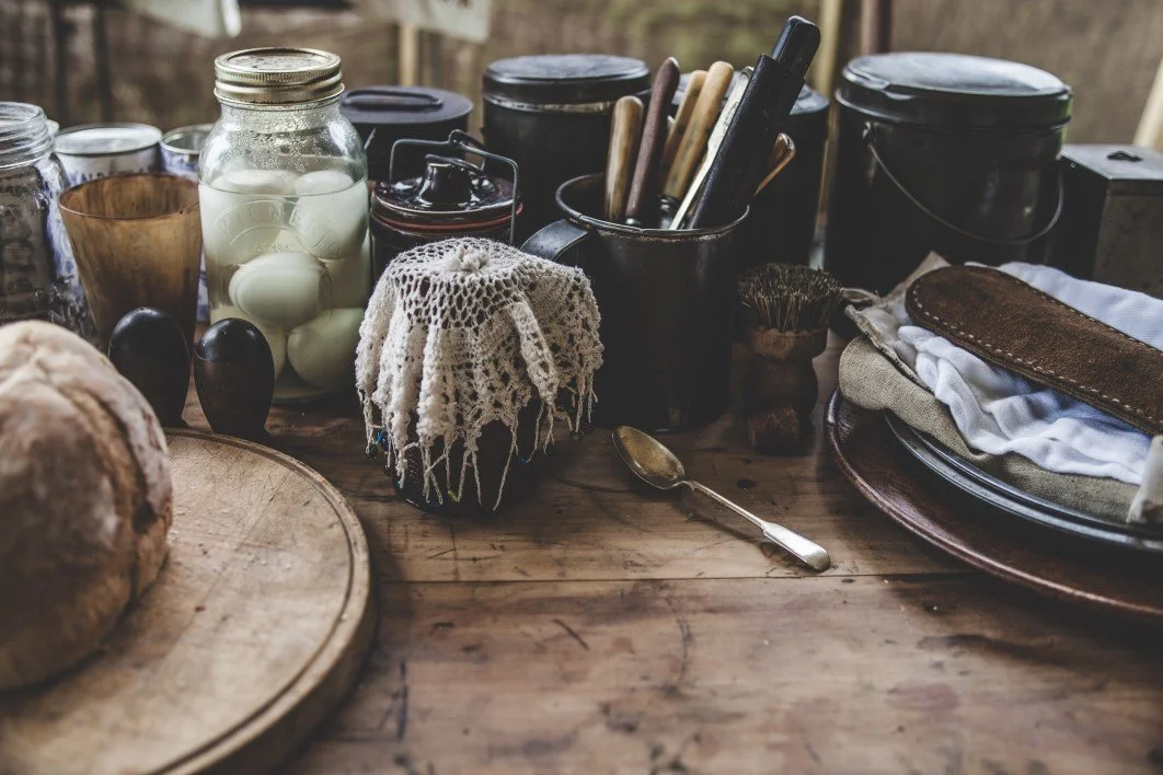 Old-fashioned wooden table displaying traditional recipes and rustic cooking ingredients