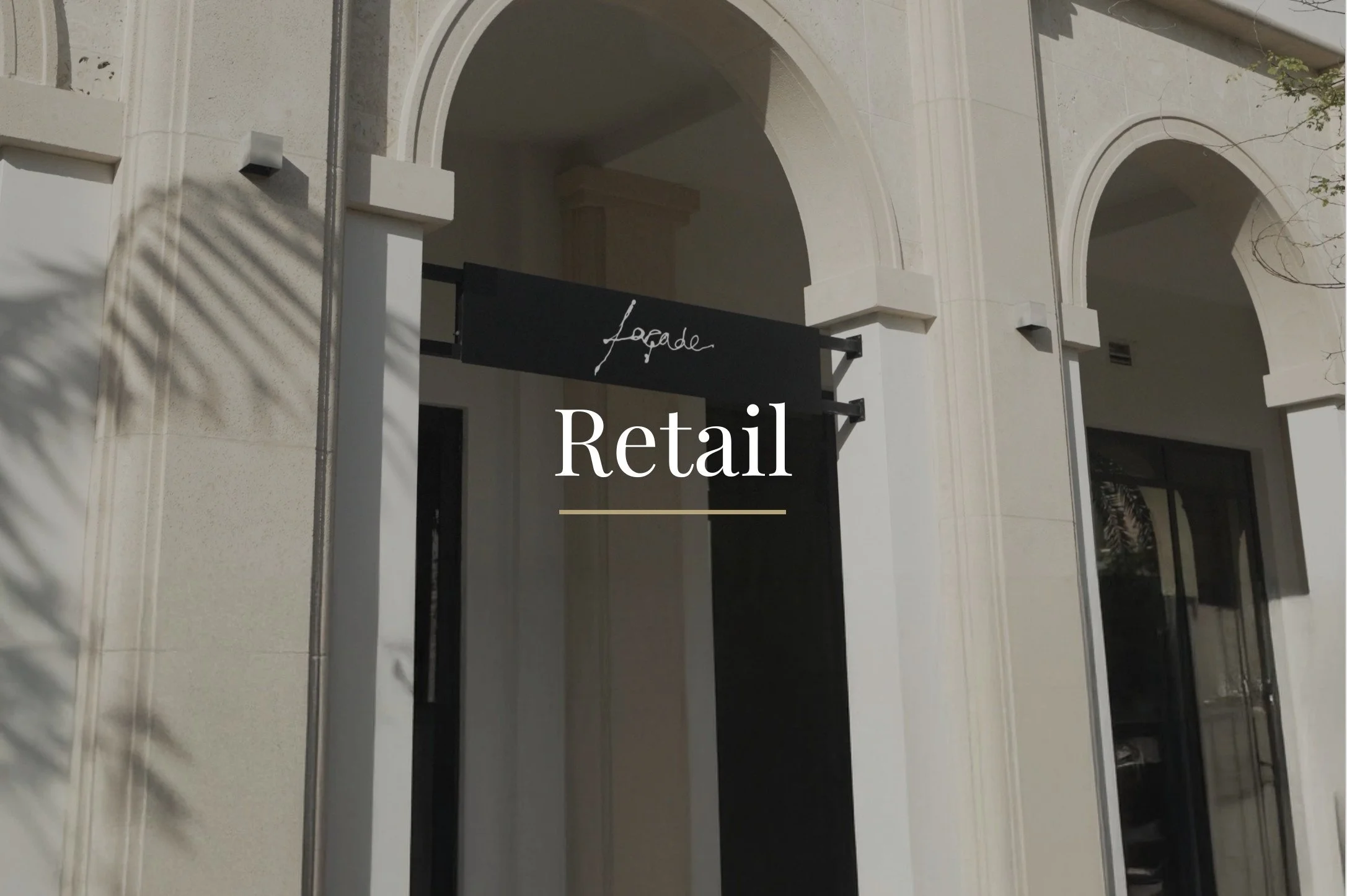 Storefront with an arched entrance and a sign reading "lodge" above the doorway, with the word "Retail" overlaid in the center.