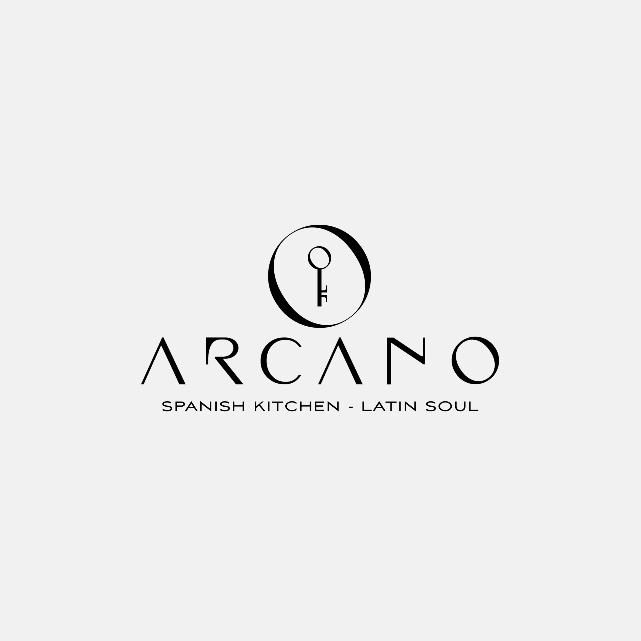 Logo for Arcano, a Spanish kitchen with Latin soul, featuring a stylized key inside a circle above the word 'Arcano' in modern font, with the tagline 'Spanish Kitchen - Latin Soul'.