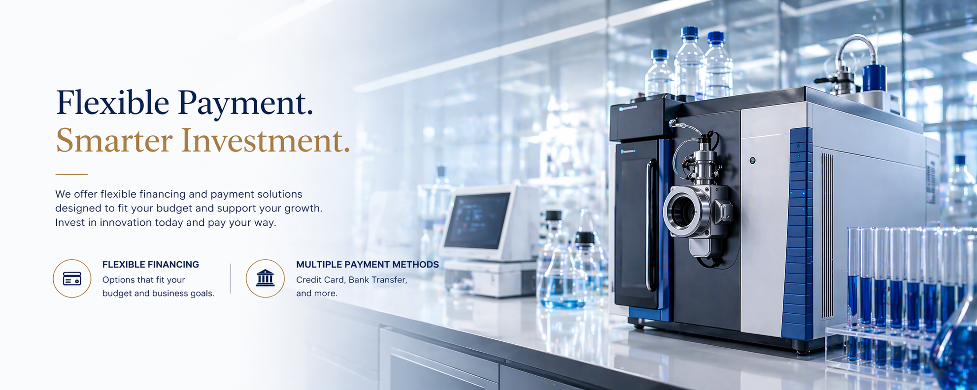 Laboratory with scientific equipment, including bottles with blue liquid, a computer, and a large machine used for experiments in a modern lab setting.