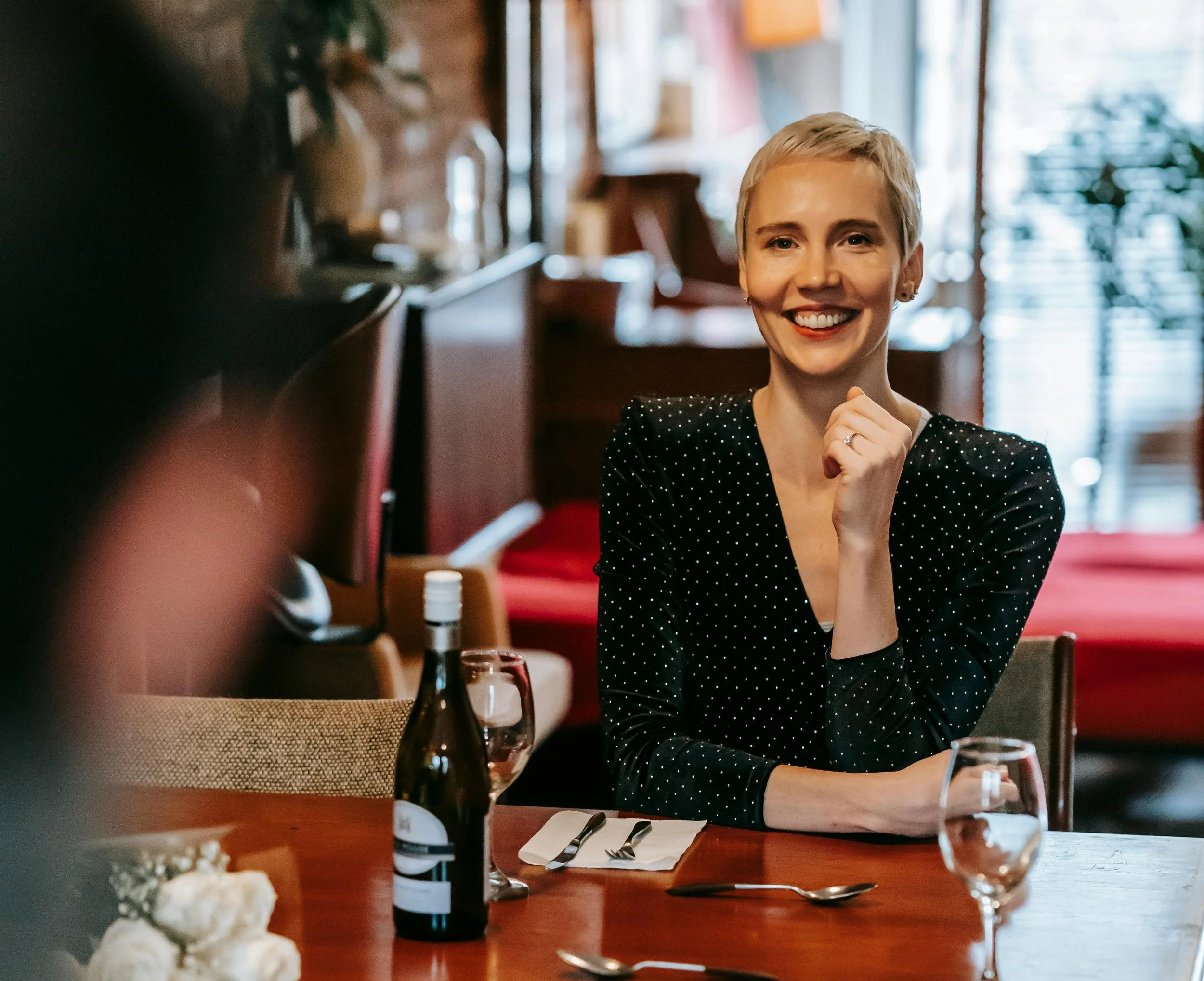A woman smiling at her date during a singles event in Tampa Bay.