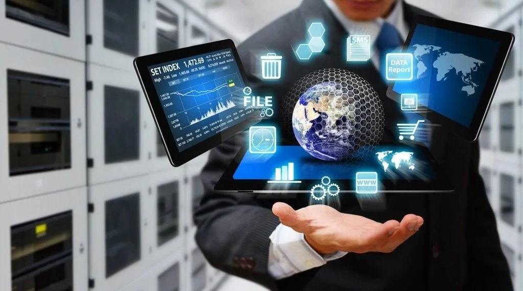A person holds out their hand with floating digital icons, including a globe, charts, files, and data reports, representing technology and data management in a server room.