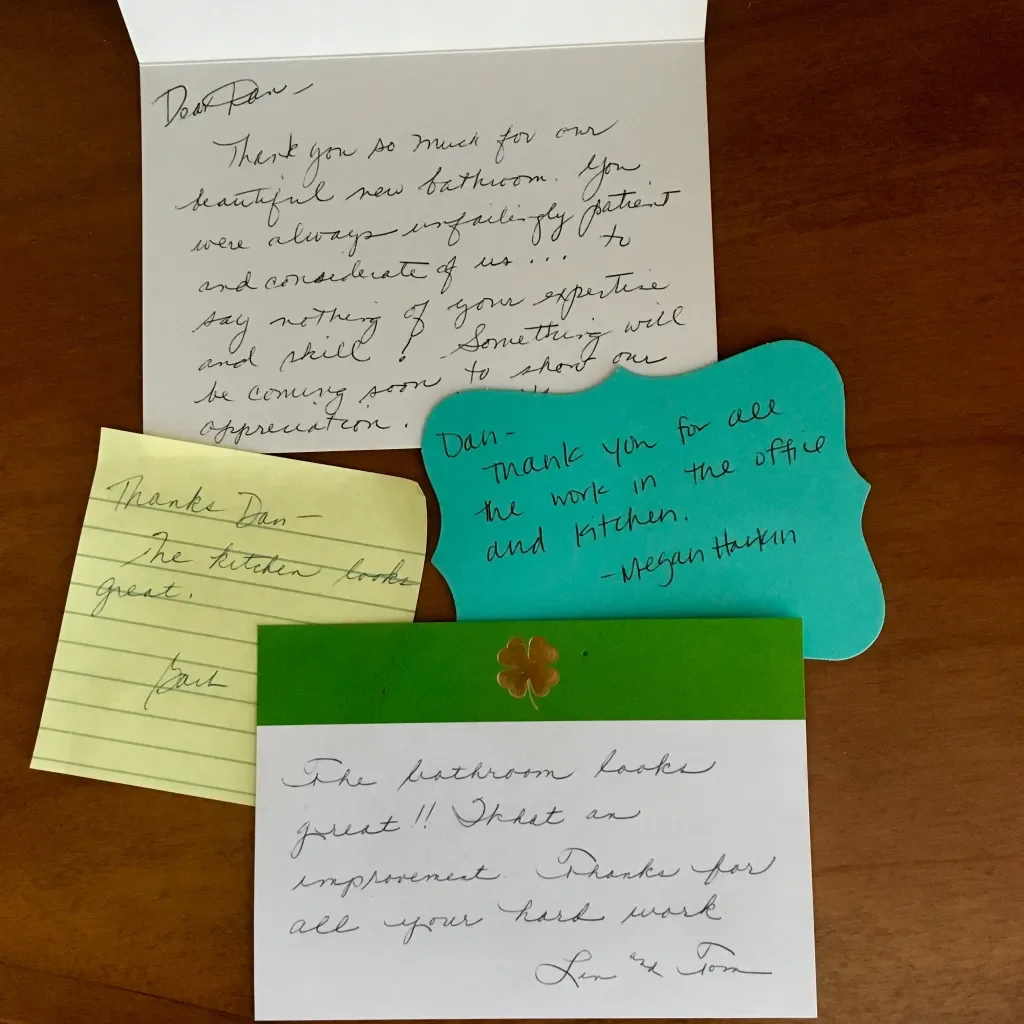 Collection of handwritten thank you notes on colorful paper, expressing gratitude for bathroom renovations.