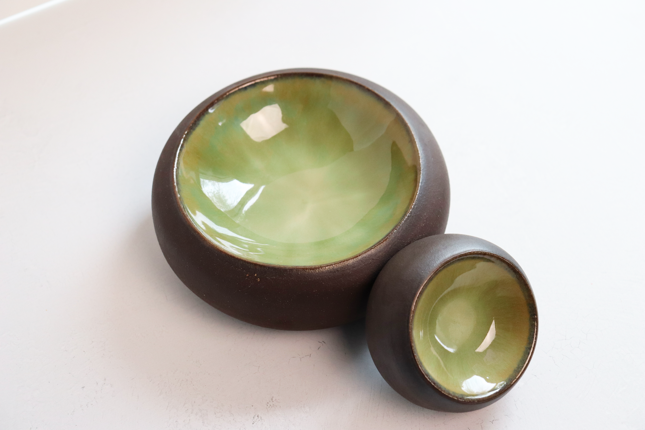 Medium and small dark stoneware bubble dishes with green glaze