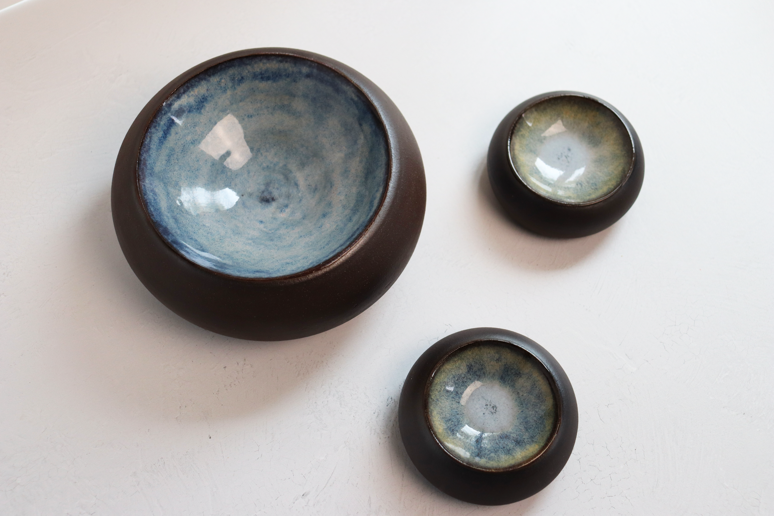 Medium and small dark stoneware bubble dishes with blue glaze