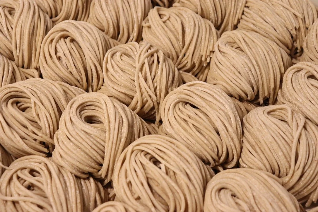 Close-up of bundles of uncooked spaghetti noodles.