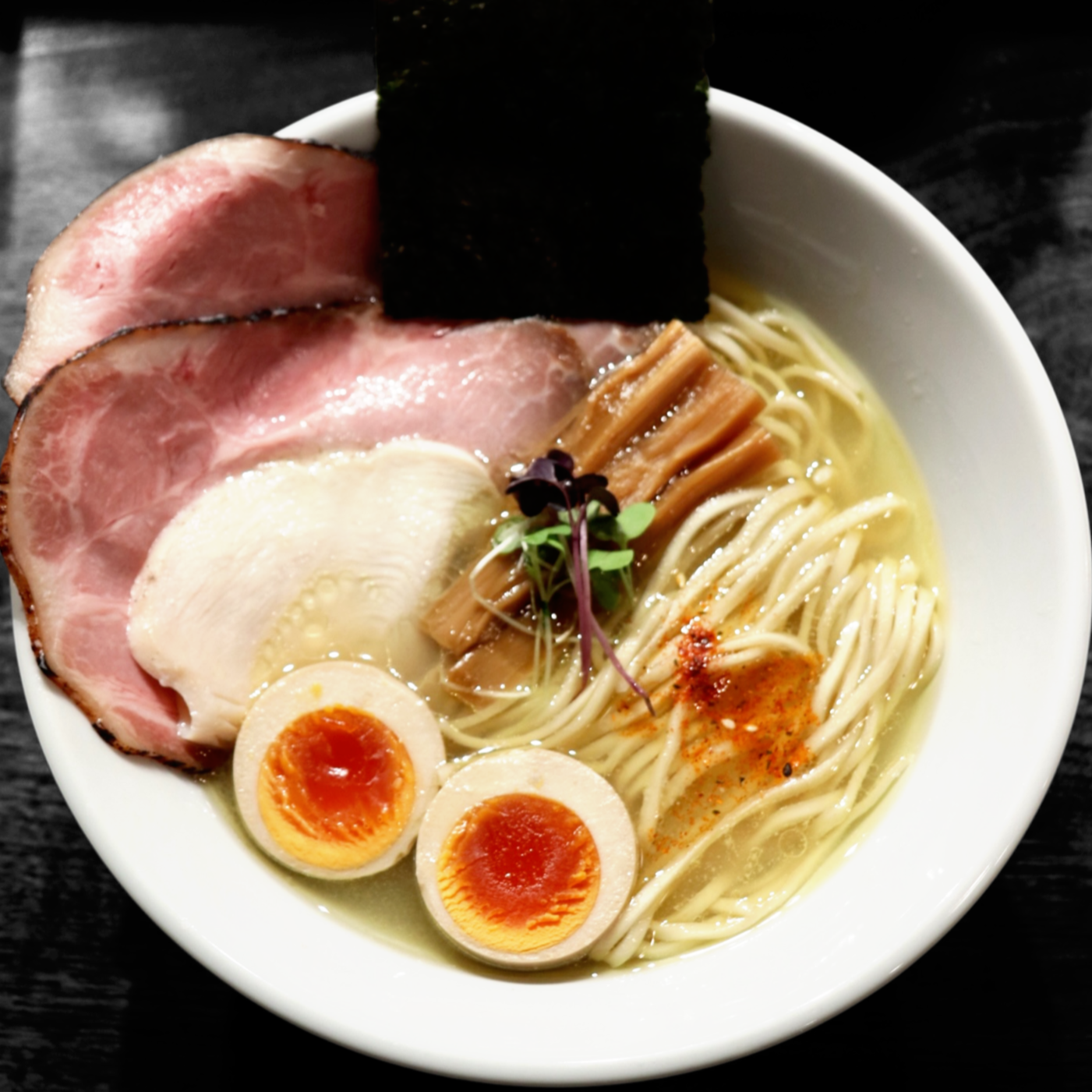 Clear konbu, niboshi, katsuo and chicken dashi, homemade noodles, pork butt chashu, chicken chashu, ajitama*, menma, local micro greens, yuzu, homemade "shichimi"