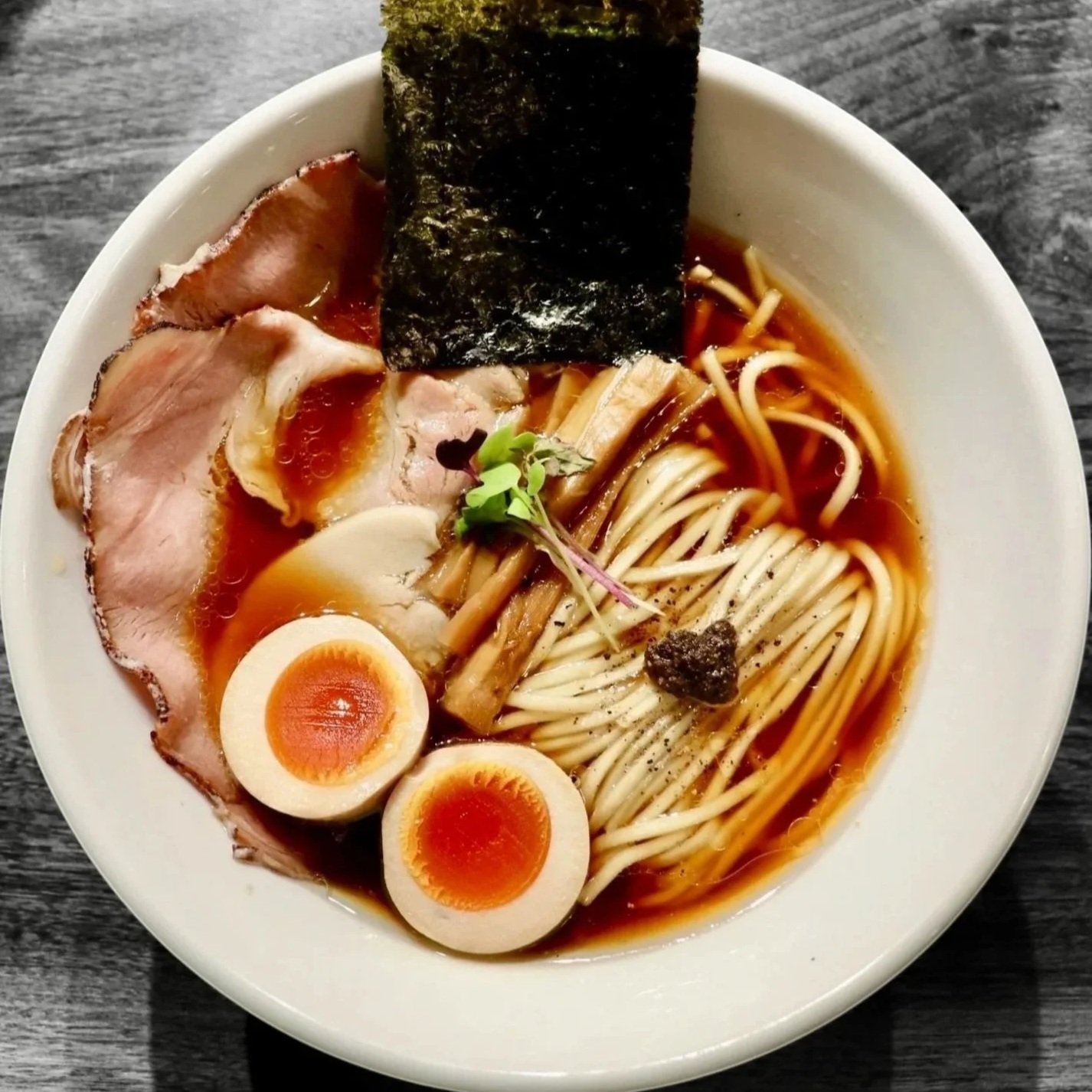 MENRI TRUFFLE SHOYU  
Clear konbu, niboshi, katsuo and chicken dashi, homemade noodles, pork butt chashu, chicken chashu, ajitama*, menma, local micro greens, truffle infused aroma oil