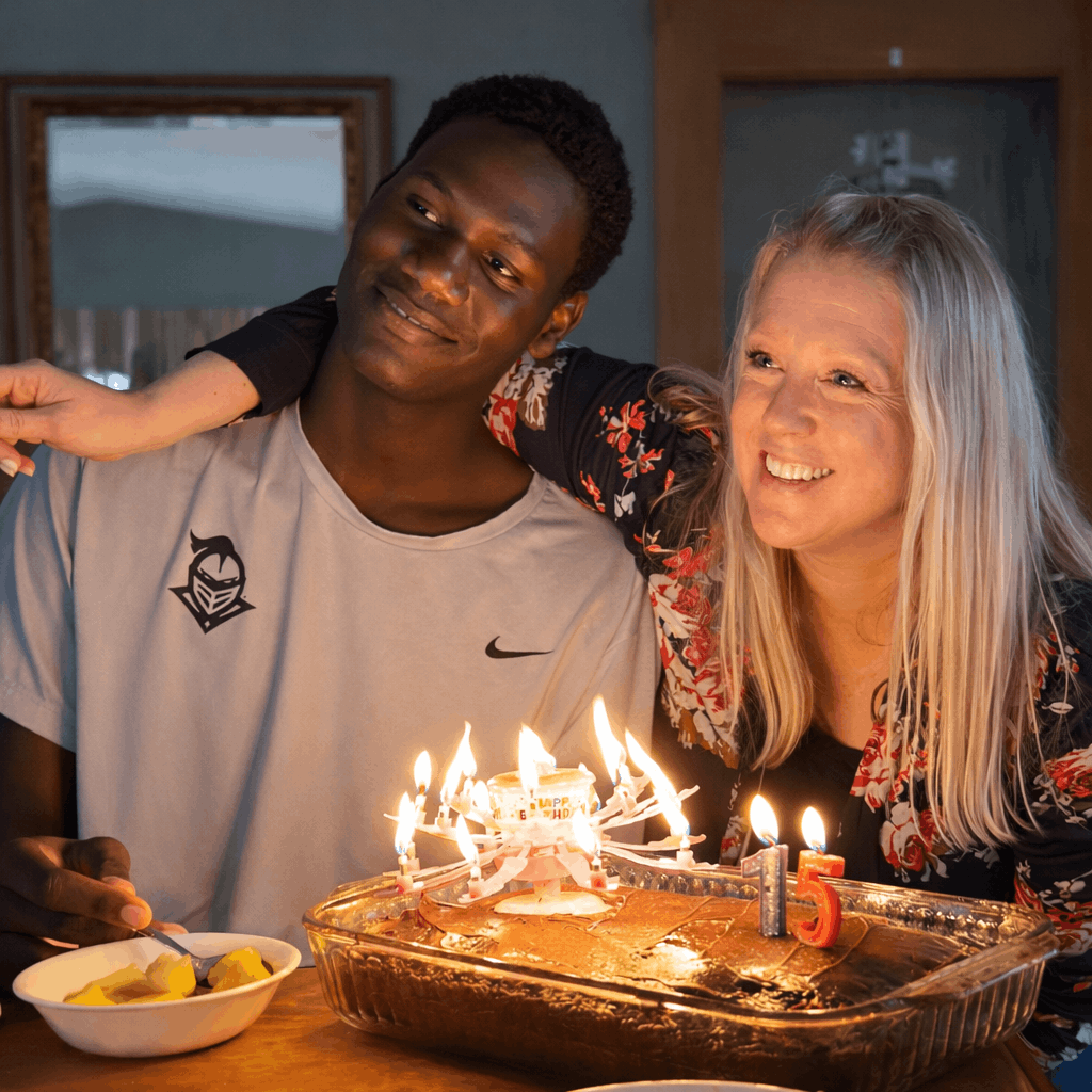 International basketball player celebrating a birthday in a supportive home environment with a caring adult.