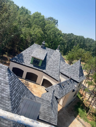 A large house roofed by Patrick and sons. 