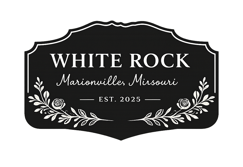 Black and white sign with decorative floral design that reads "White Rock, Marionville Missouri, Est. 2025".