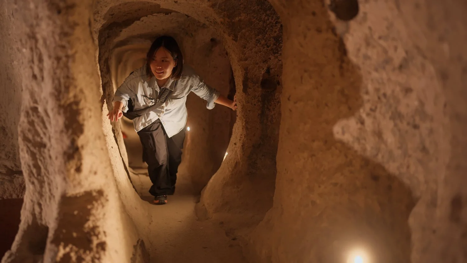 woman walking through cave tunnel symbolizing personal identity journey for second generation immigrants
