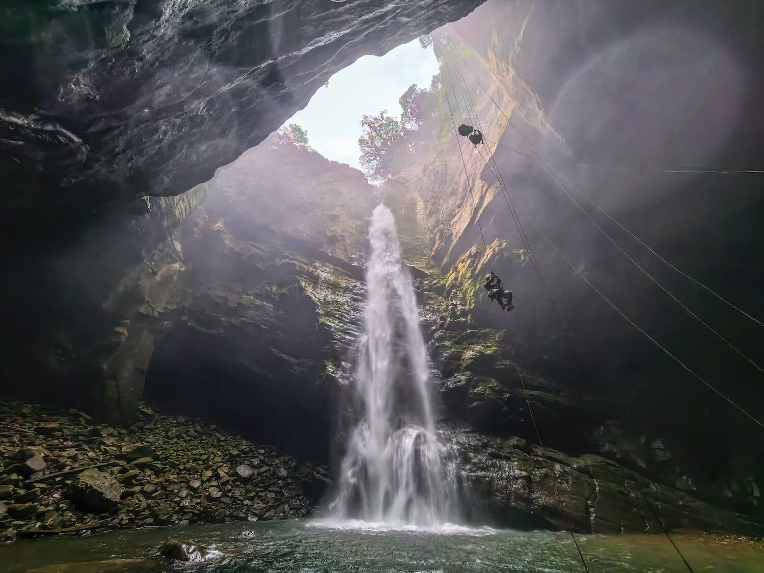 Waterfall flowing through a cave representing emotional release and healing in therapy