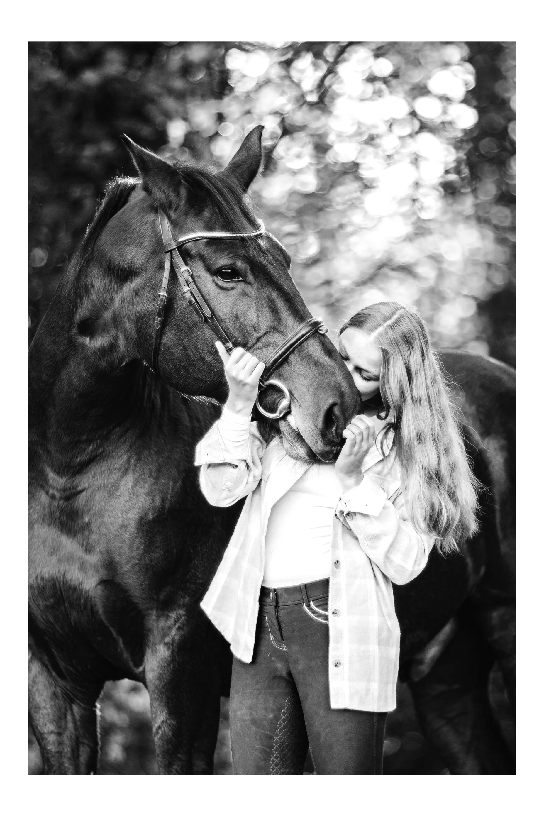 Woman embracing her heart horse, horse is wearing dressage bridle