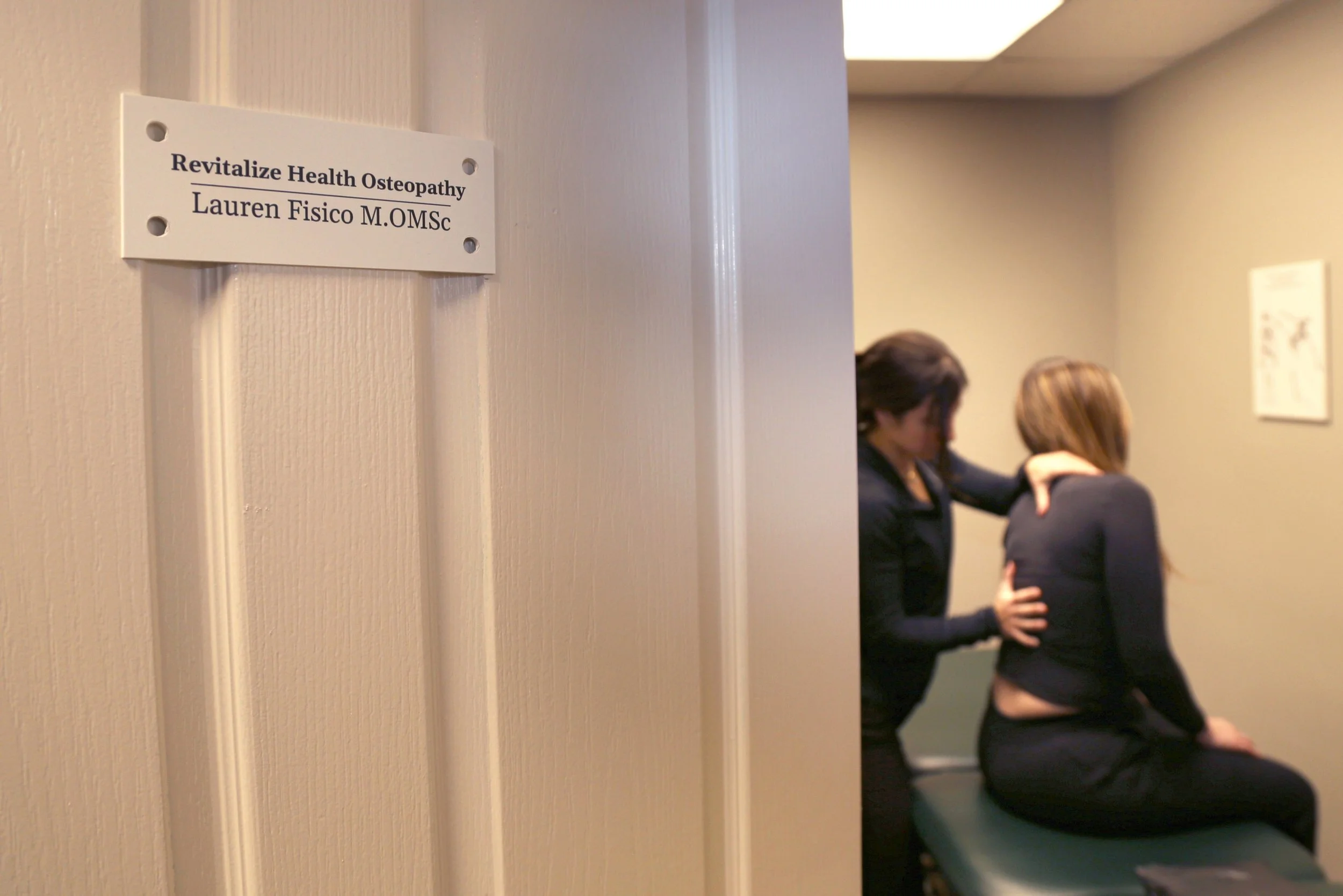osteopath business owner performing on a client with their name and business on the door in Lasalle and windsor Essex ontario