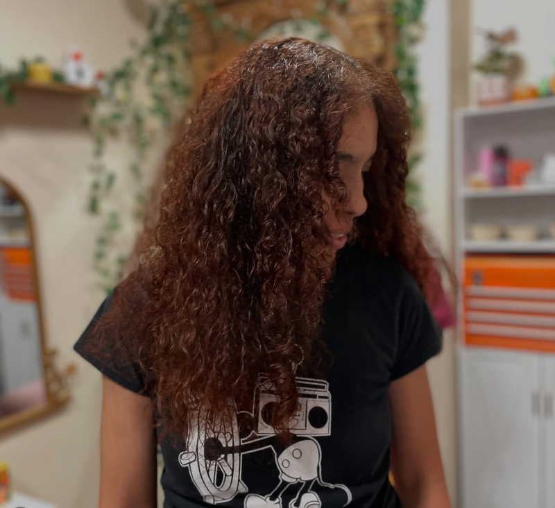 woman with healthy curly hair after haircut at bomchelle hair studio
