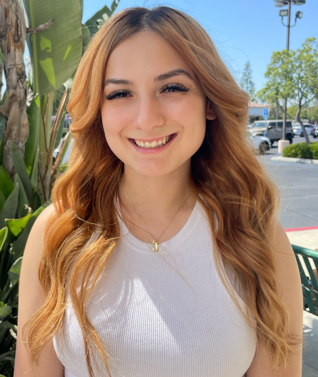 Woman with healthy, long strawberry blond hair toned at BombChelle Hair studio