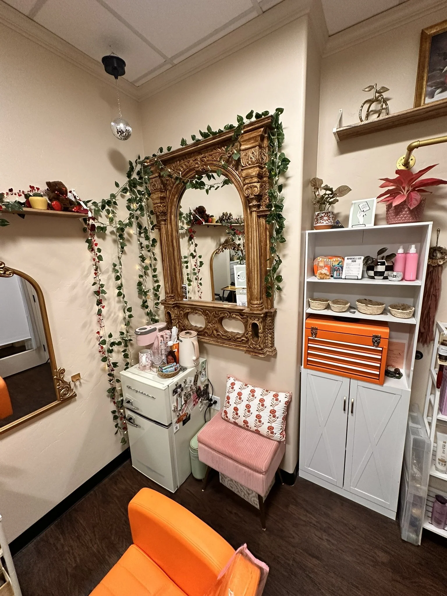 Inside BombChelle Hair studio, a cozy environment with vibrant colors, plants, and amenities
