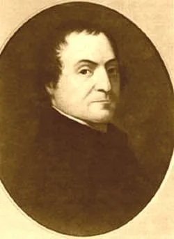 Portrait of a man with dark, curly hair, wearing a dark coat. Monochrome, vintage style.