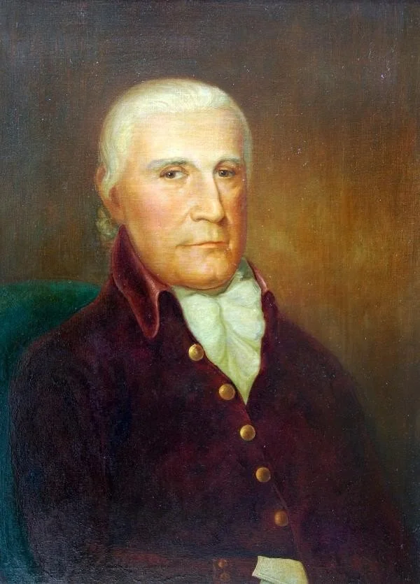 Painting of an older man with white hair, wearing a dark coat with gold buttons and a white cravat, seated against a dark background.