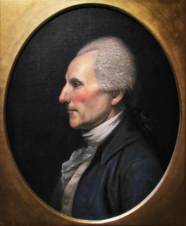 A classical portrait of a man in profile view, with gray hair, wearing period clothing, inside an oval frame.