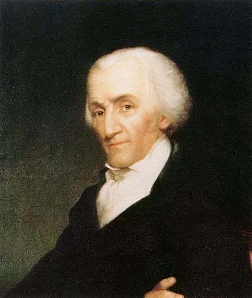 Portrait of a man with white hair, wearing a black coat and white cravat, against a dark background.