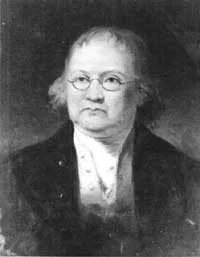 Black and white portrait of an elderly woman with glasses, wearing a dark jacket and light-colored blouse.