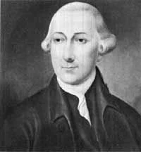 Black and white portrait of a man with shoulder-length hair, wearing a dark coat and white shirt.