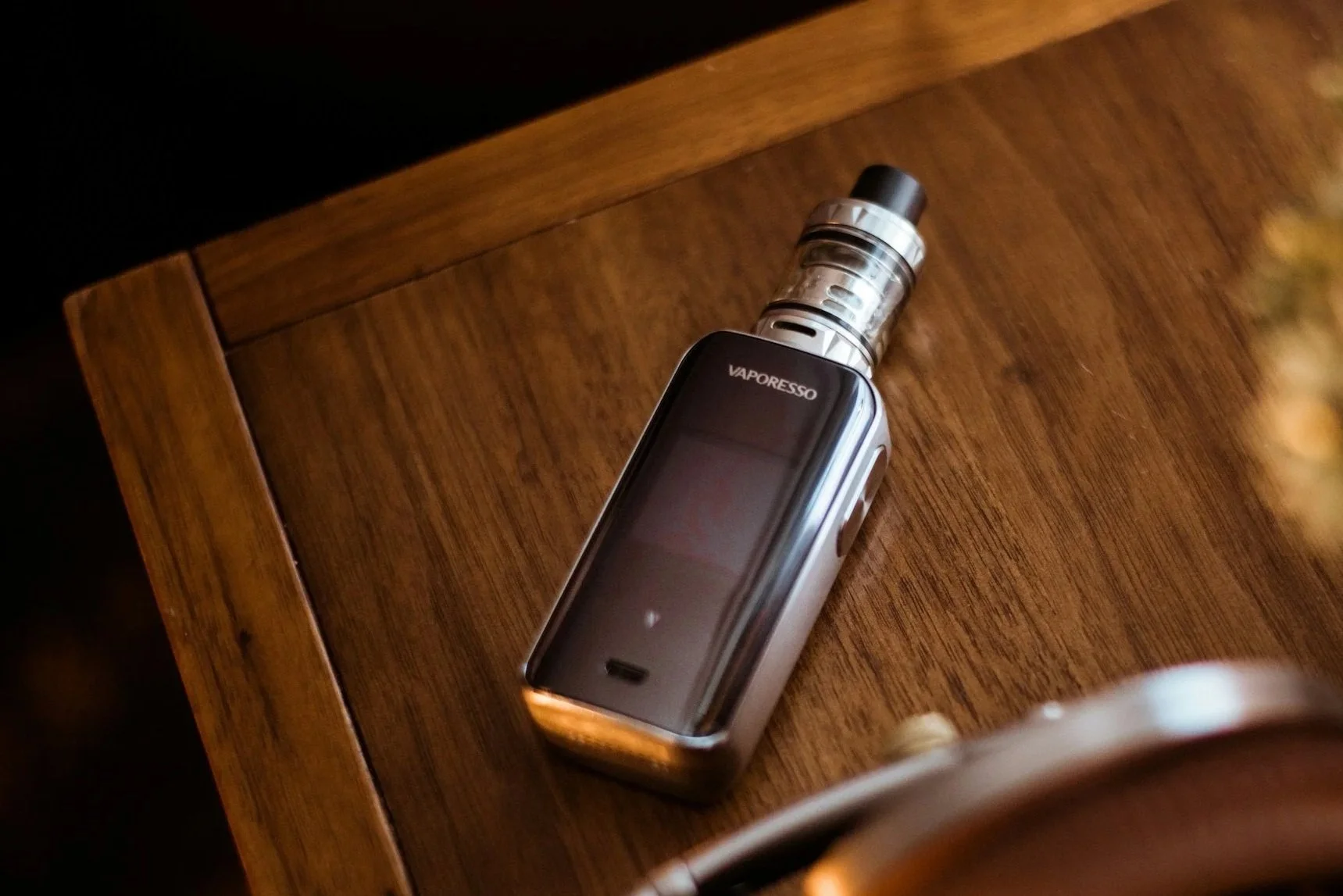 Vaporesso vape device on a wooden surface.