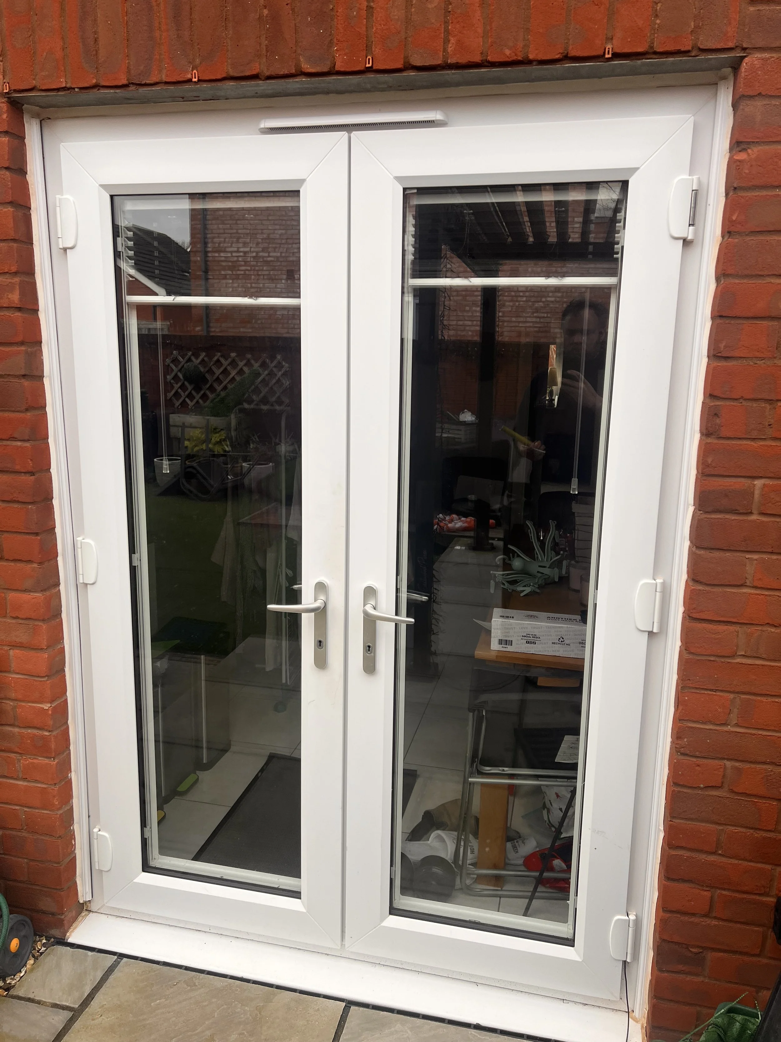 French doors realigned to resolve locking issues.