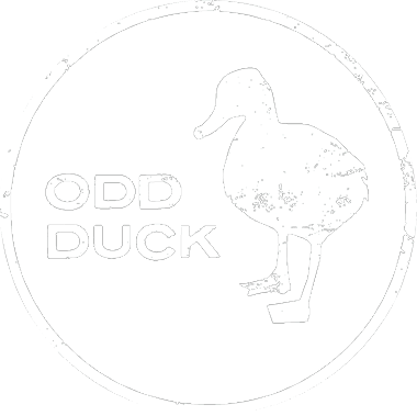 A black circular logo with a white duck silhouette and the text "ODD DUCK" inside.