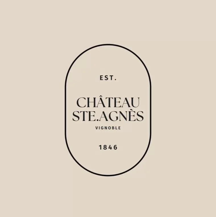 A beige background with a central oval logo outline containing the text "EST. CHÂTEAU STE. AGNÈS VIGNOBLE 1846" in black.