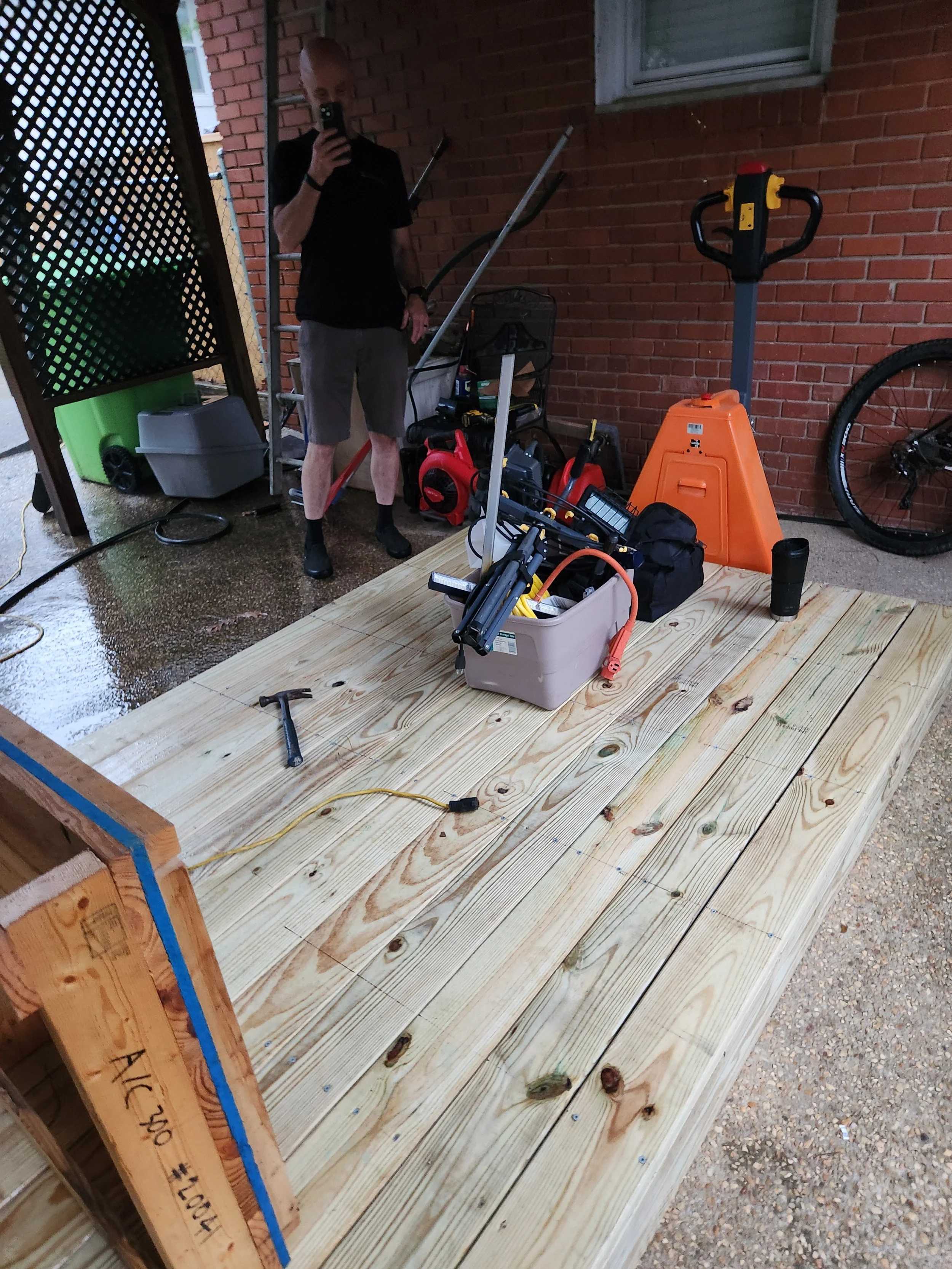 Had to build a custom pallet for the car lift. Also, do yourself a favor , spend a little more and get the electric pallet jack. It's a life saver when you're working on uneven surfaces and hauling 1300 pounds around. Wes is taking a picture of the p