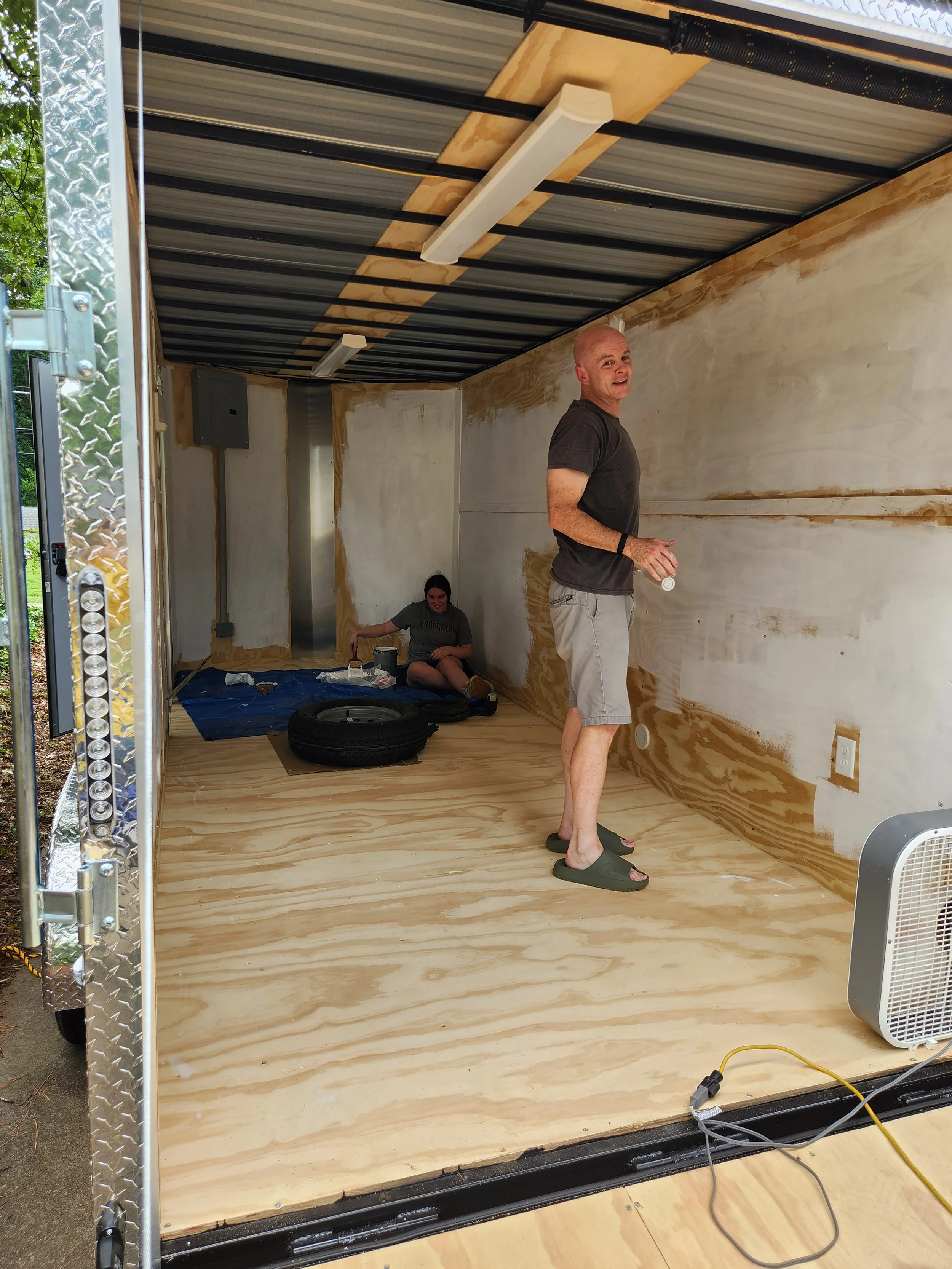 Day 1 - Painting the walls of the trailer. Wes is happy.  Do not mind the child in the back. She did not wish to be identified. She is also my daughter.
