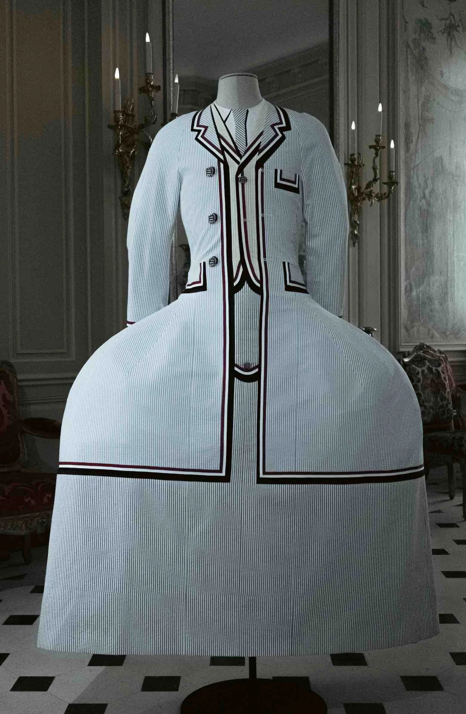 A mannequin dressed in a high-fashion, Rococco inspired suit with a modern pannier design, displayed in an ornate room with chandeliers and detailed wall decor.